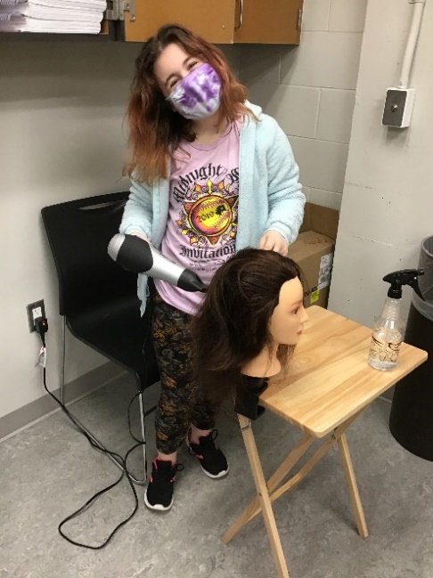 student with hair dryer