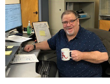 Scott Martin with a cup of coffee in his office